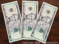 Three obverse sides of consecutive 2013 $5 notes