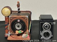 Front view of both camera decor pieces
