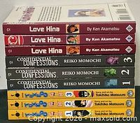 Stack of the nine manga volumes showing spines