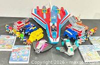 Group shot showing jet, vehicles, mini jets, figures, DVDs