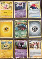 Nine Pokémon cards displayed front-side in binder page
