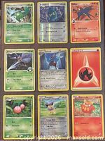 Front view of nine Pokémon cards in binder page