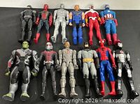 All 12 action figures laid out in two rows