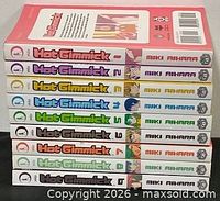 Nine Hot Gimmick volumes stacked showing spines with volume numbers 1-9