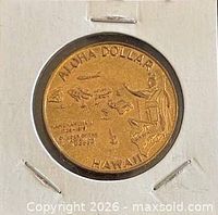 Obverse view of medal in holder showing map of islands and statue