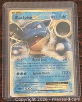 Front view of Blastoise-EX holo card inside hard sleeve