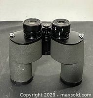 Front view of binoculars showing eyepieces, focus wheel, and textured body