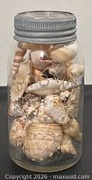 Front view of Crown Mason jar packed with shells