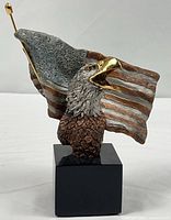 Front view showing eagle head, flag and base