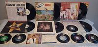Overview showing LP jackets for Stars On Long Play, Men At Work Cargo, REO Speedwagon Good Trouble, a Prism album and nine 7" singles