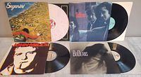 All four album jackets and records displayed