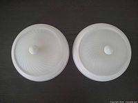 Top view of two frosted glass domes with finials