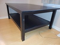 Full view of Ikea LACK coffee table, black-brown finish, showing top and shelf