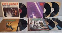 Overview of five folk album jackets and six records displayed