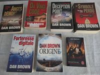 All seven Dan Brown French paperbacks laid out