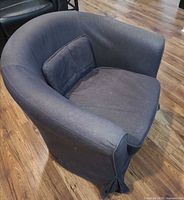 Front-angle view of dark charcoal Ikea tub armchair showing overall shape and seat cushion