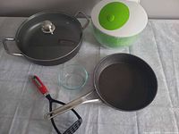 All items: salad spinner, sauté pan with lid, skillet, glass bowl, masher