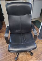 Front view of black faux leather office chair