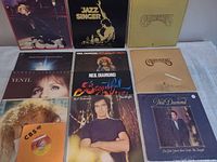Group shot of nine vinyl records showing artists and titles