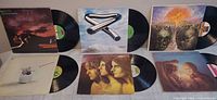 Group shot of seven LPs with covers and records displayed