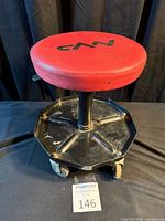 Stool full view showing seat, post, tray, casters