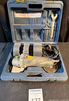 Full kit inside carrying case showing grinder, discs, handle, wrench