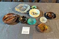 All eight ashtrays arranged on surface