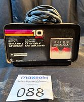 Front view of Motomaster 10A battery charger showing branding and analog ammeter