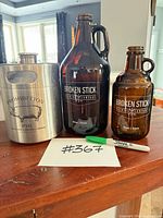 All three growlers grouped on tabletop with lot number card