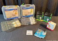 Full lot showing both Luminus cases, two NOMA LED boxes, red-white LED box, Philips blister pack