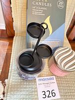 Group shot of taper candle box, jar candles, and black metal tea light holder