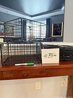 Two assembled rectangular wire baskets; shows scale and construction