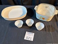 Full lot overview: square casserole with lid, oval dish, three custard cups