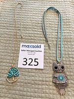 Both necklaces laid out showing full length and pendants