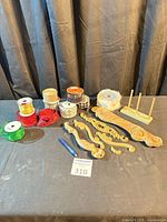 Overall lot showing ribbon spools, bow maker stand and carved wood appliques