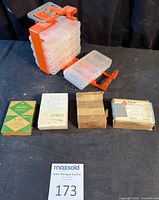 Full lot view showing five trays in carrier, one tray removed, and four boxes of staples