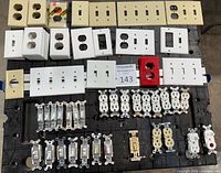 Overview of switches, receptacles and wall plates laid out on table