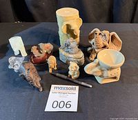 Group shot of all elephant items including candle, holder, figurines and box