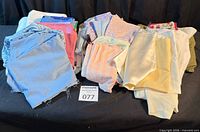 Full lot of folded fabric remnants grouped on a table