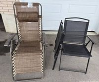 Group view of brown zero-gravity recliner and two folded black chairs