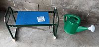 Lee Valley Tools folding kneeler stool beside green watering can