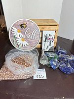 Overall lot showing sign, champagne beads, multiple mesh bags of colored beads, notebook