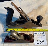 Side view of both planes with tape measure showing length