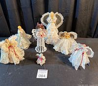 Group shot of all seven handmade angels on black backdrop