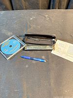 Full lot view showing harmonica, case, CD, leaflet, scale pen
