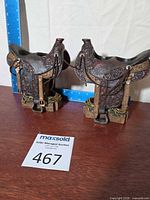 Both saddle tealight holders front view with ruler for scale