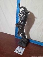 full view of sculpture with ruler for scale