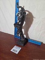 Full view of statue beside ruler showing height and base