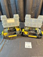 Both organizers open showing compartments filled with pegboard hooks