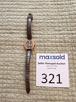 Full front view of watch laid flat showing overall design, strap length and bezel